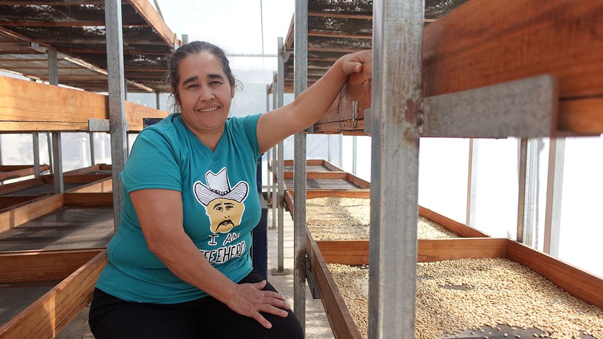 Elda Patricia Rodríguez, coffee smallholder and Panchito's wife, works drying coffee