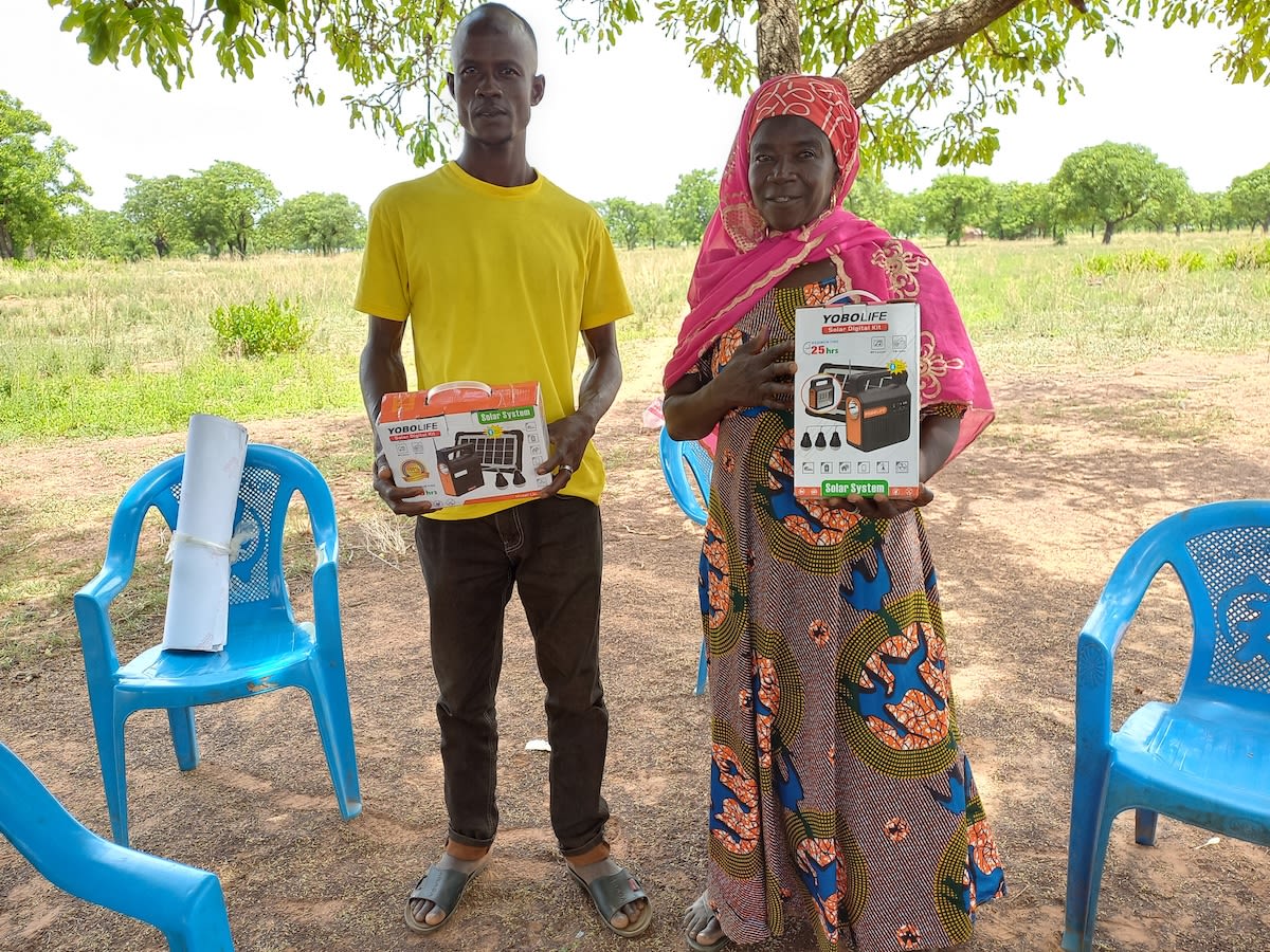Shea nut collectors receive solar-powered radios at an event in Ghana.