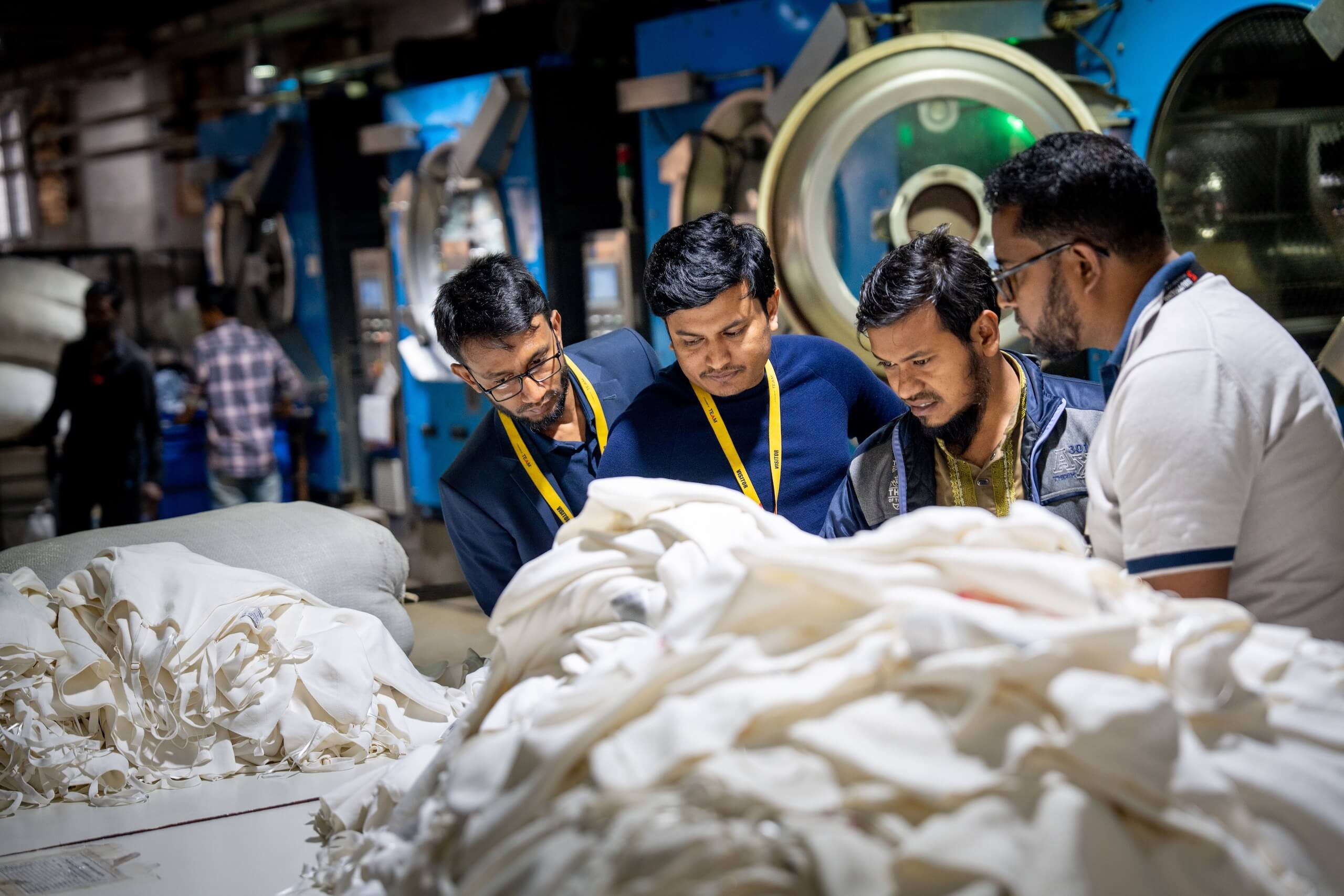 Group of people inspecting textiles