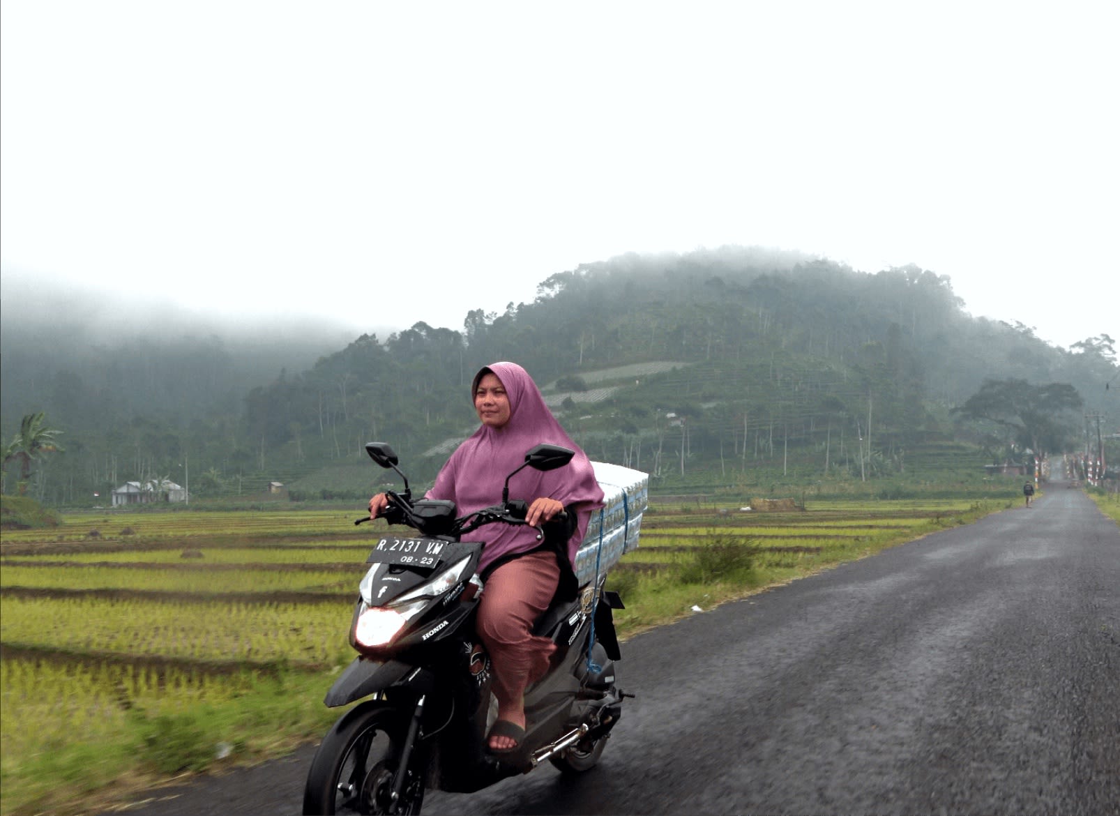 Mrs Watini riding a motorbike